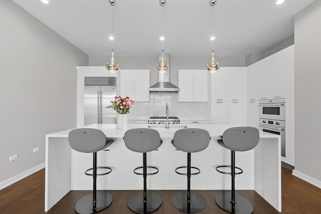 2773 N Hampden Ct Unit 401, Chicago, IL 60614 - kitchen featuring wall chimney range hood, stainless steel built in refrigerator, modern cabinets, light countertops, and white cabinets