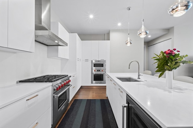 2773 N Hampden Ct Unit 401, Chicago, IL 60614 - kitchen with wall chimney range hood, appliances with stainless steel finishes, modern cabinets, light countertops, and white cabinets