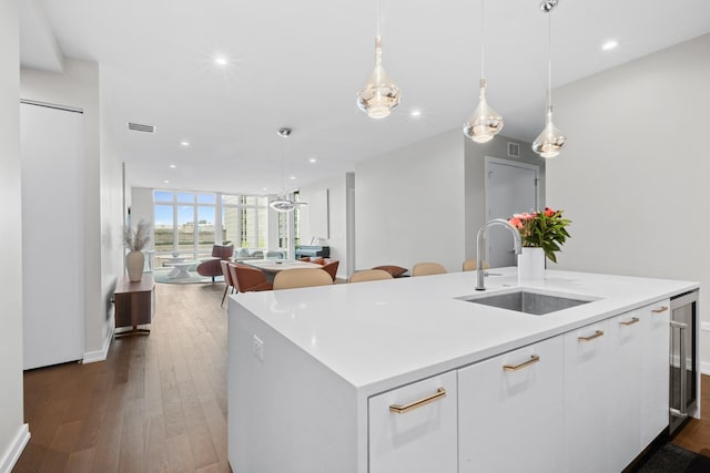 2773 N Hampden Ct Unit 401, Chicago, IL 60614 - kitchen with white cabinets, recessed lighting, dark wood-style floors, open floor plan, and an island with sink