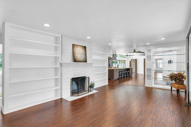 3408 E University Ave, Urbana, IL 61802 - living area with a ceiling fan, wood finished floors, built in features, a stone fireplace, and recessed lighting