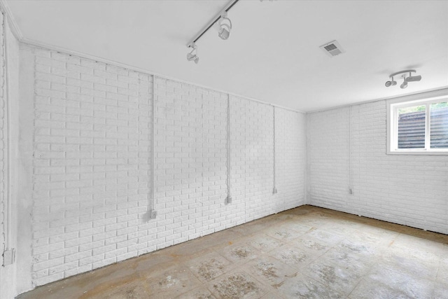 3408 E University Ave, Urbana, IL 61802 - empty room with brick wall and rail lighting