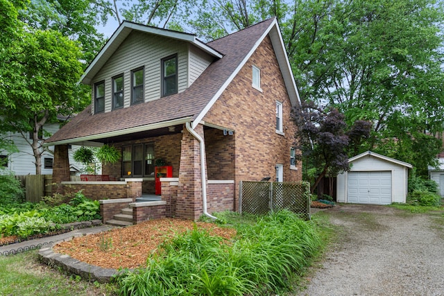 711 W Iowa St, Urbana, IL 61801 - view of front of property with an outdoor structure, covered porch, a garage, brick siding, and driveway