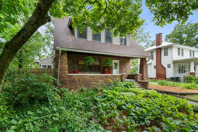711 W Iowa St, Urbana, IL 61801 - view of front facade featuring brick siding, a porch, and a shingled roof