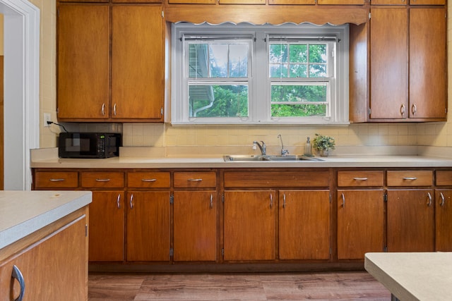 711 W Iowa St, Urbana, IL 61801 - kitchen featuring a sink, black microwave, and light countertops
