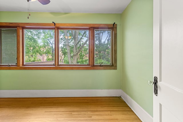 711 W Iowa St, Urbana, IL 61801 - unfurnished room featuring wood finished floors, baseboards, and a ceiling fan