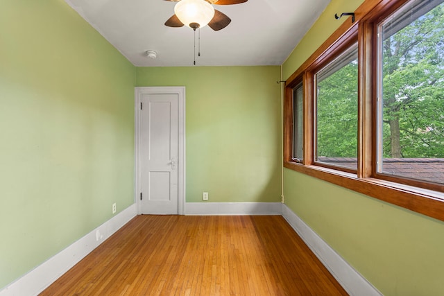 711 W Iowa St, Urbana, IL 61801 - spare room featuring baseboards, ceiling fan, and light wood-style floors