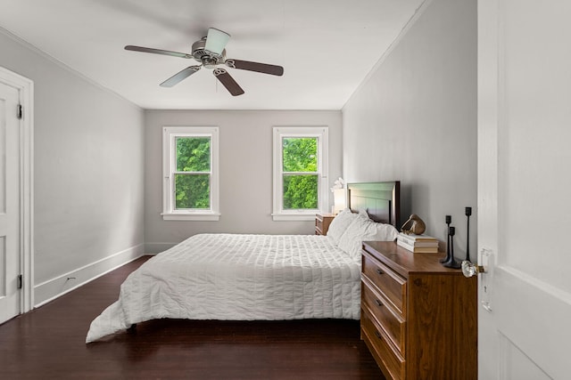 711 W Iowa St, Urbana, IL 61801 - bedroom with dark wood-type flooring, baseboards, crown molding, and ceiling fan