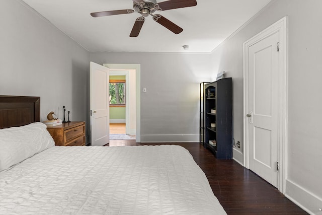 711 W Iowa St, Urbana, IL 61801 - bedroom with ornamental molding, dark wood-type flooring, baseboards, and ceiling fan