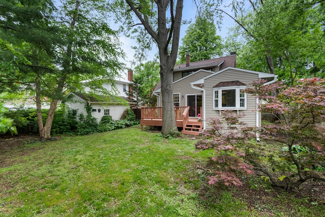 711 W Iowa St, Urbana, IL 61801 - view of front of house featuring a front lawn, a chimney, and a wooden deck
