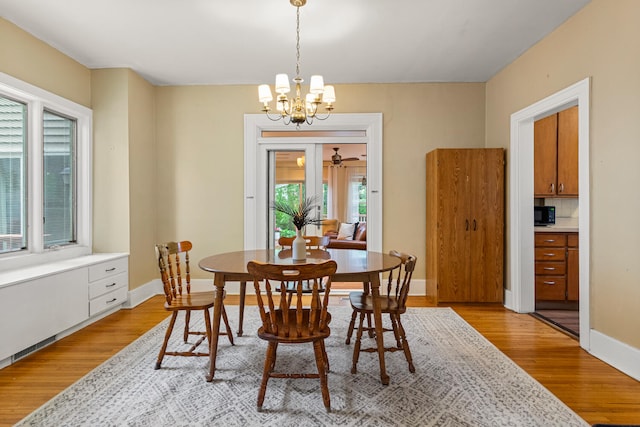 711 W Iowa St, Urbana, IL 61801 - dining room with light wood-style floors, healthy amount of natural light, and a chandelier