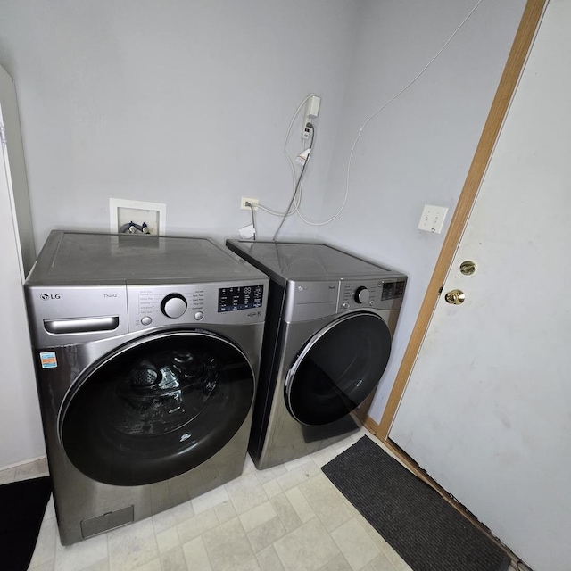 laundry room featuring washing machine and clothes dryer