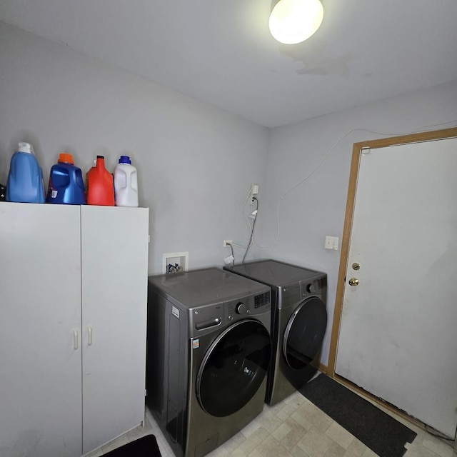 laundry room featuring washing machine and clothes dryer and light floors