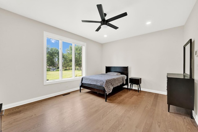 bedroom featuring baseboards, wood finished floors, recessed lighting, and ceiling fan