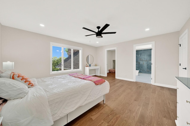 bedroom featuring wood finished floors, baseboards, recessed lighting, a ceiling fan, and ensuite bathroom
