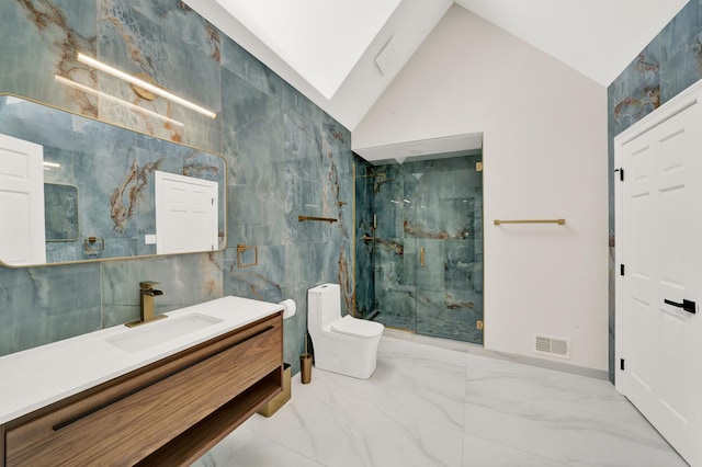 full bathroom featuring marble finish floors, a marble finish shower, toilet, lofted ceiling, and vanity