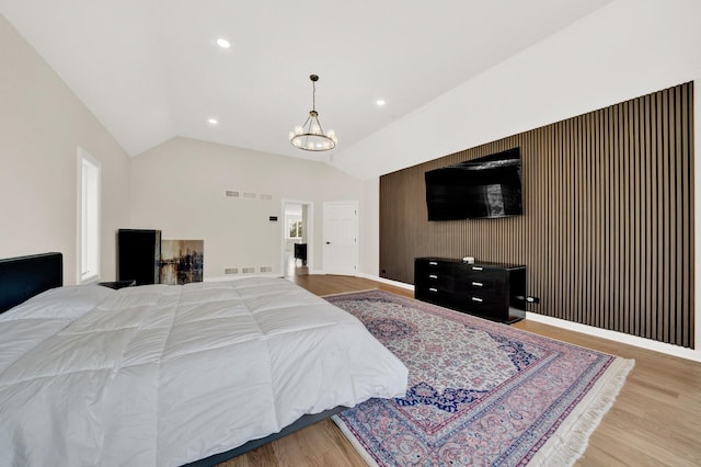 bedroom featuring wood finished floors, a chandelier, vaulted ceiling, recessed lighting, and baseboards