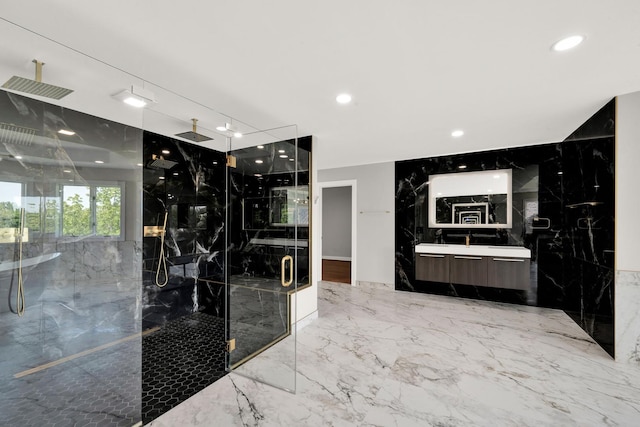 bathroom featuring a marble finish shower, marble tiled floors, vanity, and recessed lighting