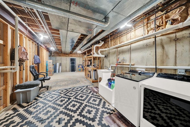 unfinished below grade area with washer and clothes dryer