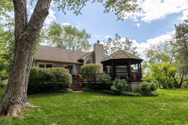7038 Bentley Dr, Gurnee, IL 60031 - rear view of house with a gazebo, a chimney, a lawn, and a deck