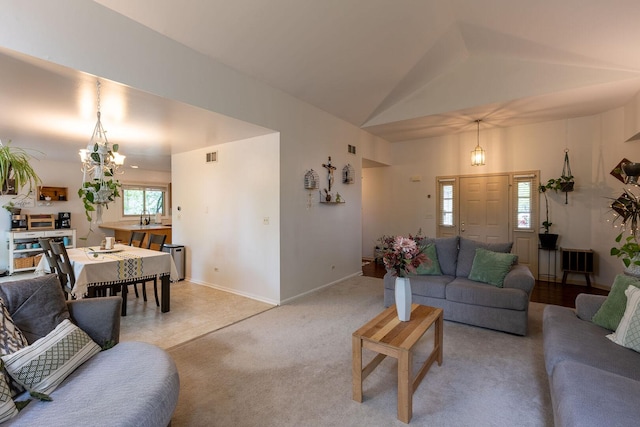 7038 Bentley Dr, Gurnee, IL 60031 - living area with a chandelier, vaulted ceiling, baseboards, and light carpet
