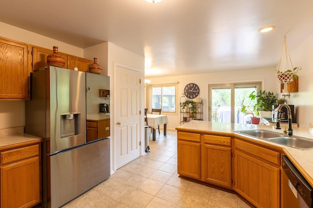 7038 Bentley Dr, Gurnee, IL 60031 - kitchen featuring appliances with stainless steel finishes, a sink, light tile patterned floors, brown cabinetry, and light countertops