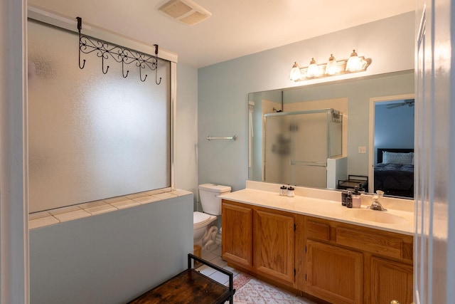 7038 Bentley Dr, Gurnee, IL 60031 - bathroom featuring a shower stall, connected bathroom, double vanity, toilet, and ceiling fan