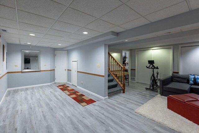 7038 Bentley Dr, Gurnee, IL 60031 - finished basement featuring wood finished floors, a paneled ceiling, stairs, baseboards, and recessed lighting