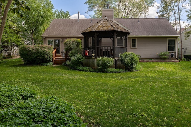7038 Bentley Dr, Gurnee, IL 60031 - rear view of house with a deck, a lawn, a chimney, and a shingled roof
