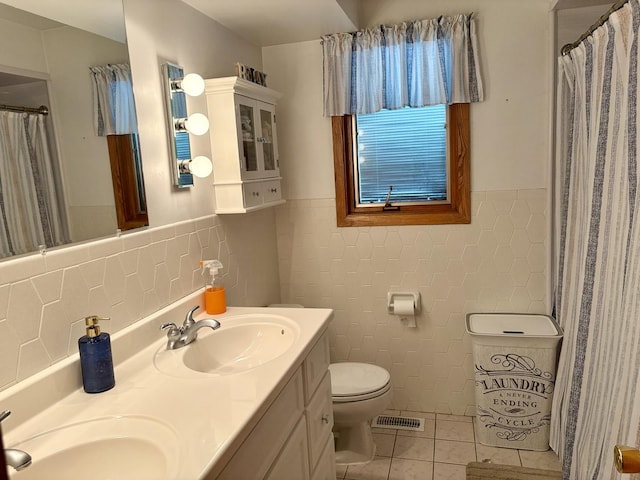5600 Saint Charles Rd, Berkeley, IL 60163 - full bath with tile walls, tile patterned floors, toilet, a wainscoted wall, and double vanity