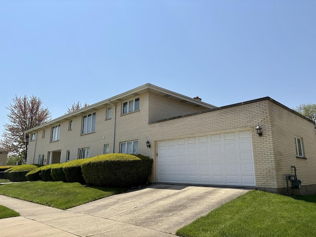 5600 Saint Charles Rd, Berkeley, IL 60163 - view of side of home with brick siding, concrete driveway, a yard, and an attached garage