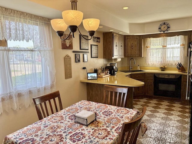 5600 Saint Charles Rd, Berkeley, IL 60163 - kitchen featuring oven, a sink, healthy amount of natural light, and light countertops