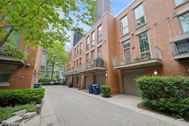 456 E N Water St Unit H, Chicago, IL 60611 - view of building exterior featuring an attached garage and driveway