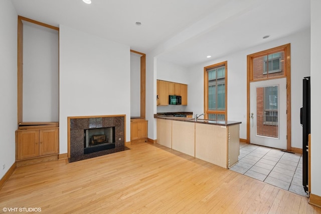 456 E N Water St Unit H, Chicago, IL 60611 - kitchen featuring black microwave, light wood-style flooring, a peninsula, dark countertops, and recessed lighting
