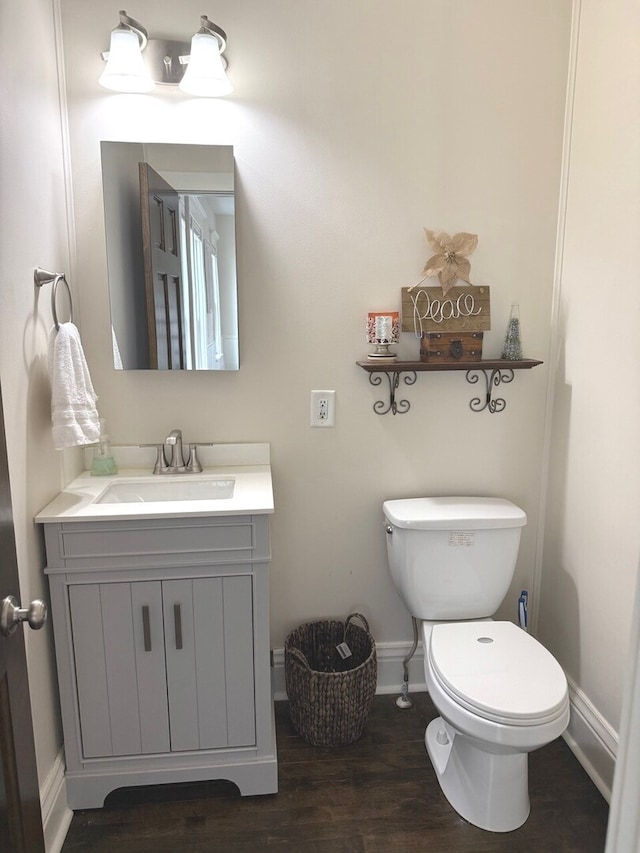 4731 E 10th Rd, Earlville, IL 60518 - bathroom featuring baseboards, vanity, toilet, and wood finished floors