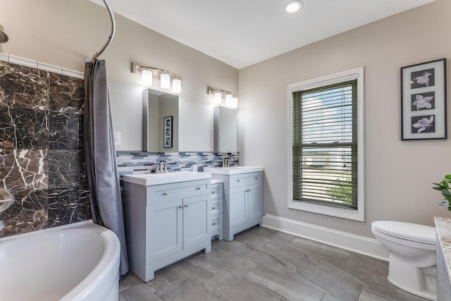 4731 E 10th Rd, Earlville, IL 60518 - bathroom featuring vanity, healthy amount of natural light, backsplash, toilet, and recessed lighting