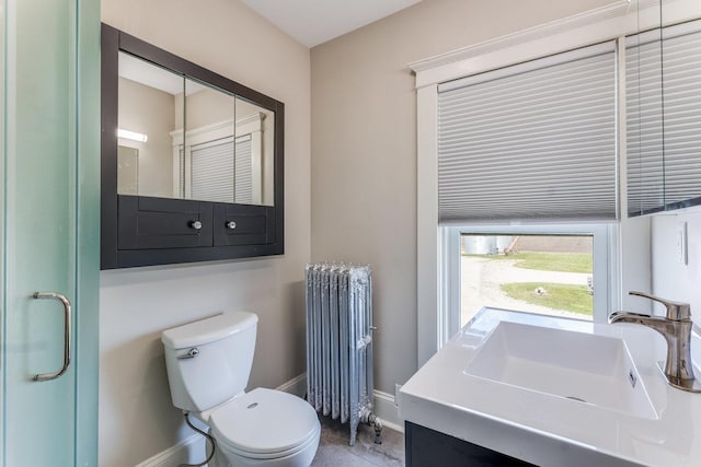 4731 E 10th Rd, Earlville, IL 60518 - bathroom featuring radiator heating unit, toilet, baseboards, and vanity