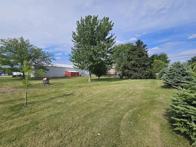 4731 E 10th Rd, Earlville, IL 60518 - view of grassy yard featuring an outbuilding and a pole building