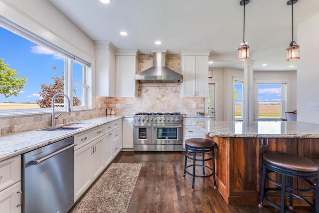 4731 E 10th Rd, Earlville, IL 60518 - kitchen featuring stainless steel appliances, wall chimney range hood, a kitchen breakfast bar, dark wood-style floors, and tasteful backsplash