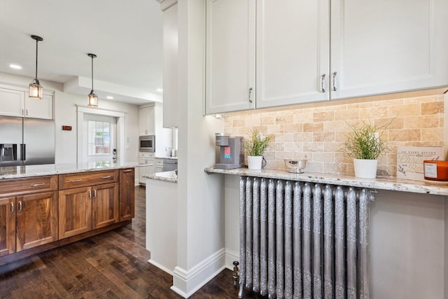 4731 E 10th Rd, Earlville, IL 60518 - kitchen with radiator, built in appliances, dark wood finished floors, decorative backsplash, and light stone counters
