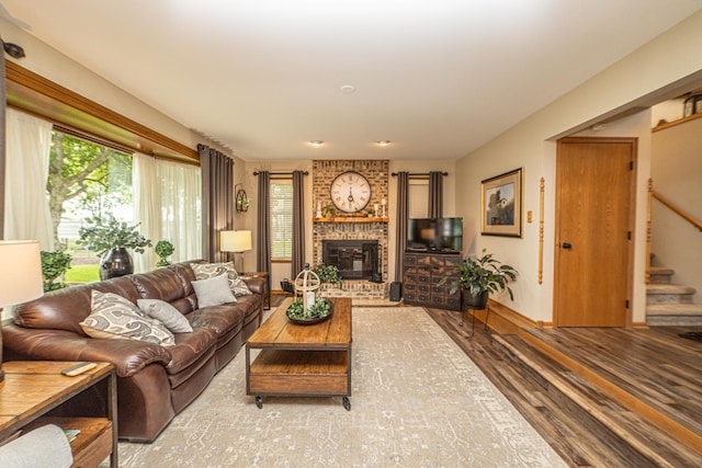 25037 W Liberty Dr, Channahon, IL 60410 - living room with wood finished floors, stairs, a fireplace, and baseboards