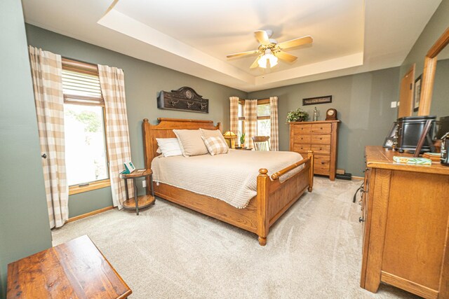 25037 W Liberty Dr, Channahon, IL 60410 - bedroom featuring a tray ceiling, light carpet, baseboards, and ceiling fan