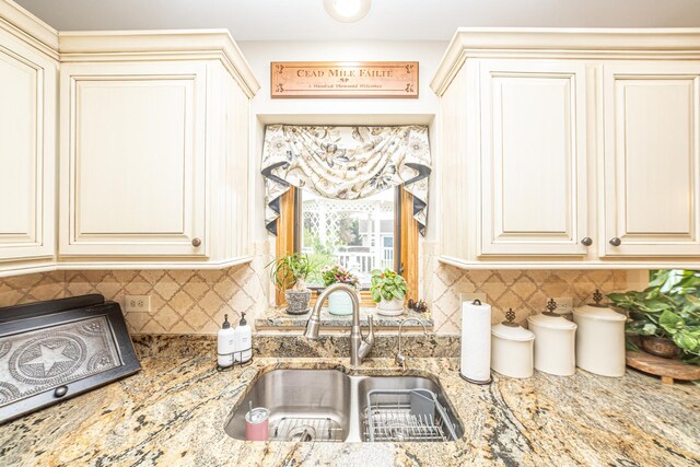 25037 W Liberty Dr, Channahon, IL 60410 - kitchen featuring a sink, cream cabinets, and tasteful backsplash