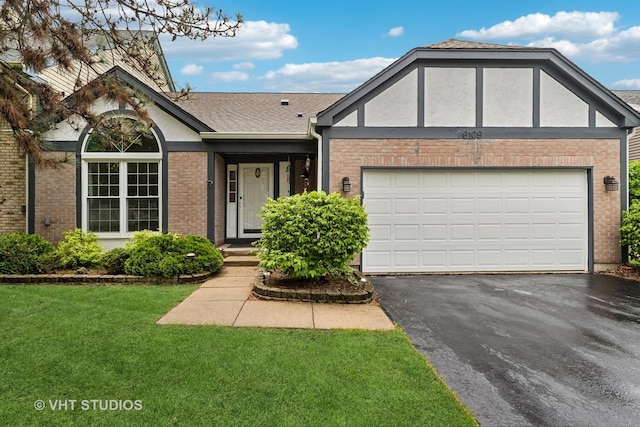 6109 Golfview Dr Unit 6109, Gurnee, IL 60031 - view of front of house with brick siding, driveway, a front lawn, an attached garage, and roof with shingles