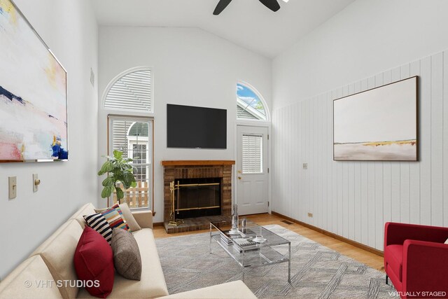 6109 Golfview Dr Unit 6109, Gurnee, IL 60031 - living area featuring wood finished floors, ceiling fan, a brick fireplace, and high vaulted ceiling