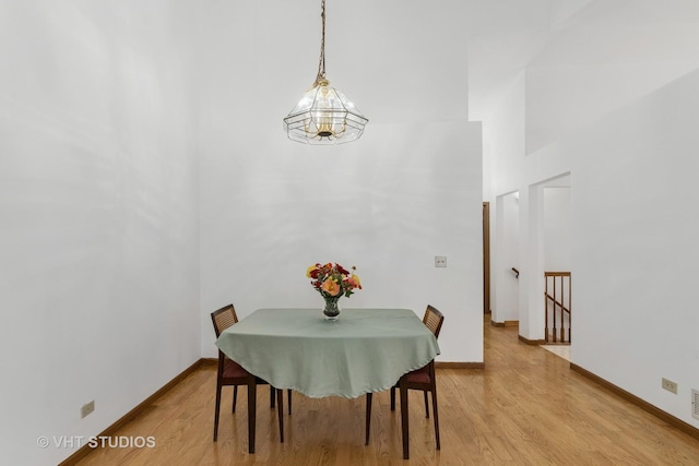 6109 Golfview Dr Unit 6109, Gurnee, IL 60031 - dining space with a chandelier, light wood-style floors, and a high ceiling