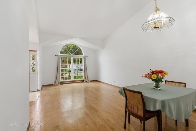 6109 Golfview Dr Unit 6109, Gurnee, IL 60031 - dining space featuring light wood finished floors, a chandelier, and high vaulted ceiling