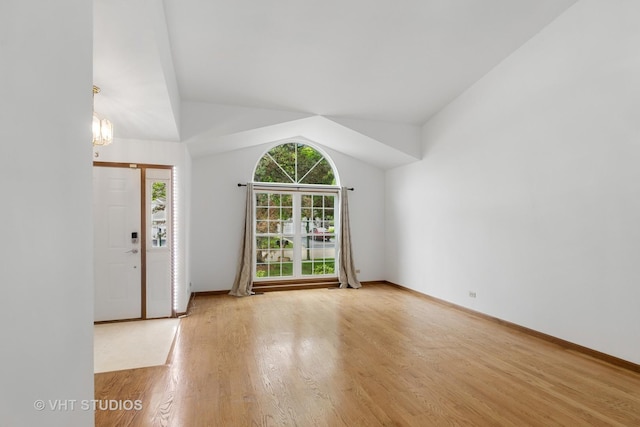 6109 Golfview Dr Unit 6109, Gurnee, IL 60031 - unfurnished living room with wood finished floors, lofted ceiling, and a chandelier