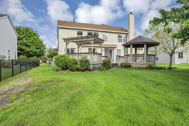 rear view of property with a pergola, a gazebo, a chimney, and a deck