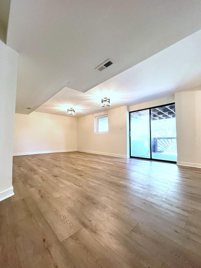 unfurnished room featuring hardwood / wood-style flooring and baseboards