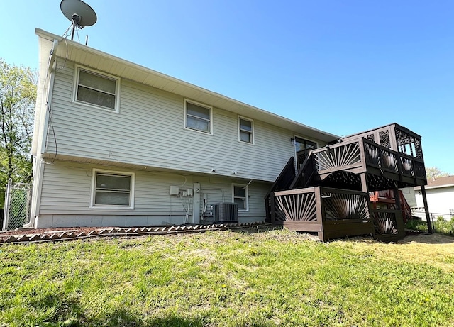 rear view of property with cooling unit and a deck